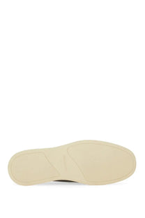 Cream-colored rubber sole with minimalist design and subtle embossed branding on ferragamo men’s moccasin gancini black