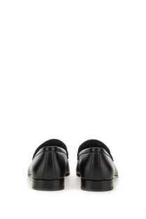 Black leather Ferragamo men’s moccasin Gancini loafers with sleek polished finish and classic slip-on design