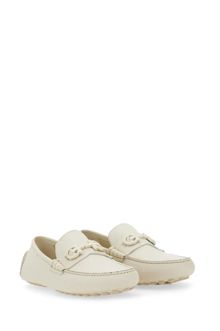 Cream-colored Ferragamo men’s moccasin with braided leather detailing and signature double g buckle loafers