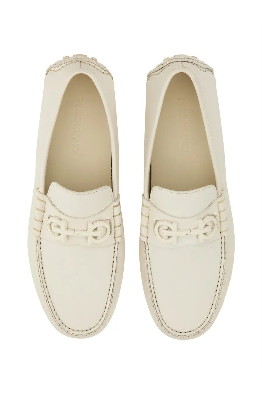 Cream-colored ferragamo men’s moccasin white loafers with smooth leather finish and signature double g buckle detail