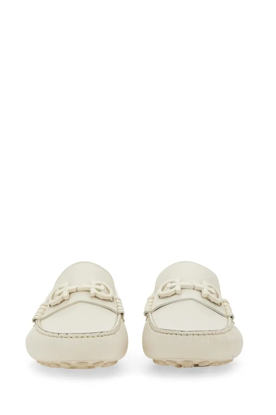 Cream-colored leather Ferragamo men’s moccasin with g-shaped metal buckle and braided detailing