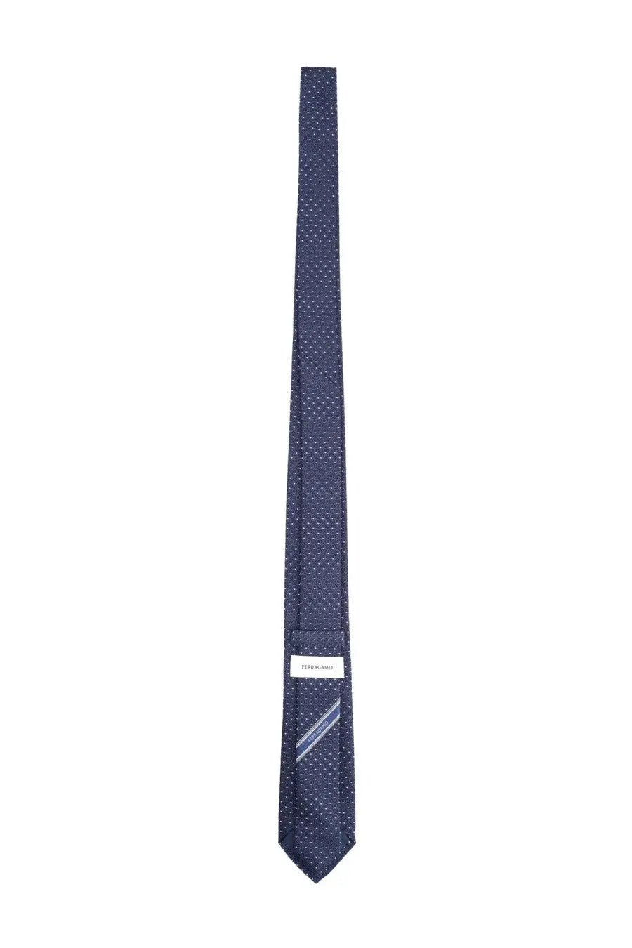 Ferragamo men’s navy blue silk tie with subtle white dot pattern and ferragamo brand label at the base