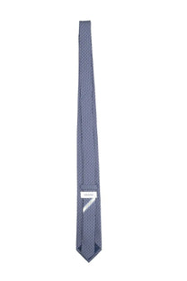 A navy blue silk tie with a subtle geometric pattern and ferragamo brand label at the base