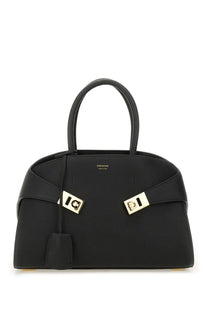 Ferragamo women’s borsa tote hug black leather handbag with gold-tone hardware and distinctive front clasp design