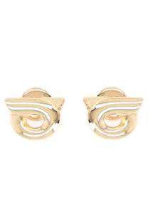 Ferragamo women’s gold-toned stud earrings with abstract wing design and polished concentric circular patterns