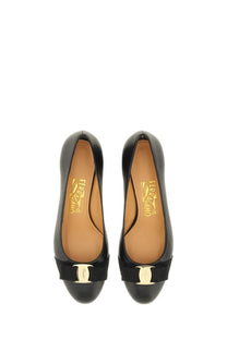 Ferragamo women’s leather vara shoe black featuring black patent leather pumps with gold tone buckle and ribbon detail