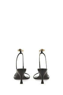 Ferragamo women’s black patent leather sandals with gold-tone chain and decorative clasp detail