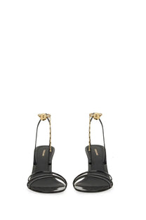 Ferragamo women’s black patent leather strappy sandals with gold-tone chain detailing and logo charm at ankle strap