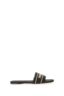 Ferragamo women’s black slide sandal with gold-tone lettering and trim for stylish casual wear