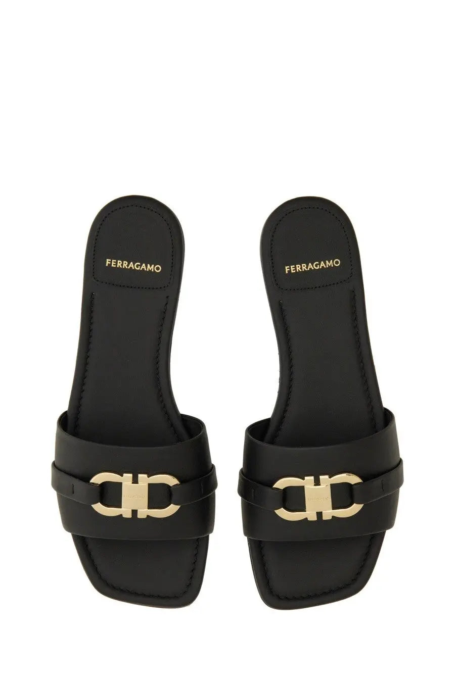 Ferragamo women’s black leather slide sandals with gold-tone double c logo buckle