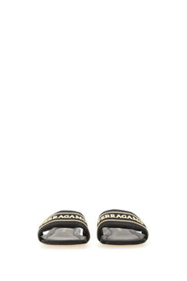 Ferragamo women’s black slide sandal with gold-tone lettering on leather strap for casual wear