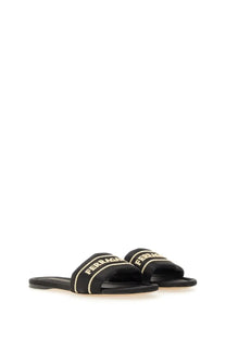 Ferragamo women’s black slide sandal with gold-tone embroidered branding and striped detailing