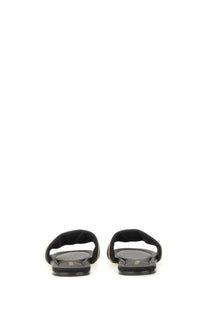Ferragamo women’s black suede slide sandal with sleek minimalist design and subtle gold trim along edges