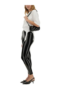 Fiorucci women’s white shirt paired with black glossy patent leather leggings featuring white stripes and silver zippers