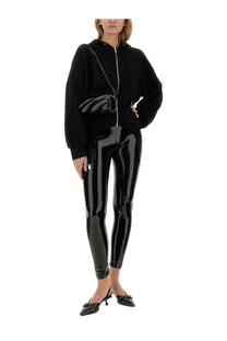 Black patent leather crossbody bag with circular clasp and chain strap featured with Fiorucci women’s sweatshirt black
