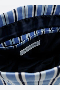 The frankie shop women’s morgan pochette blue features navy and white striped fabric lining with a silver label