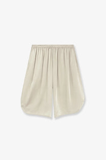 Beige satin bermuda shorts with elastic waistband and relaxed flowing silhouette from the frankie shop