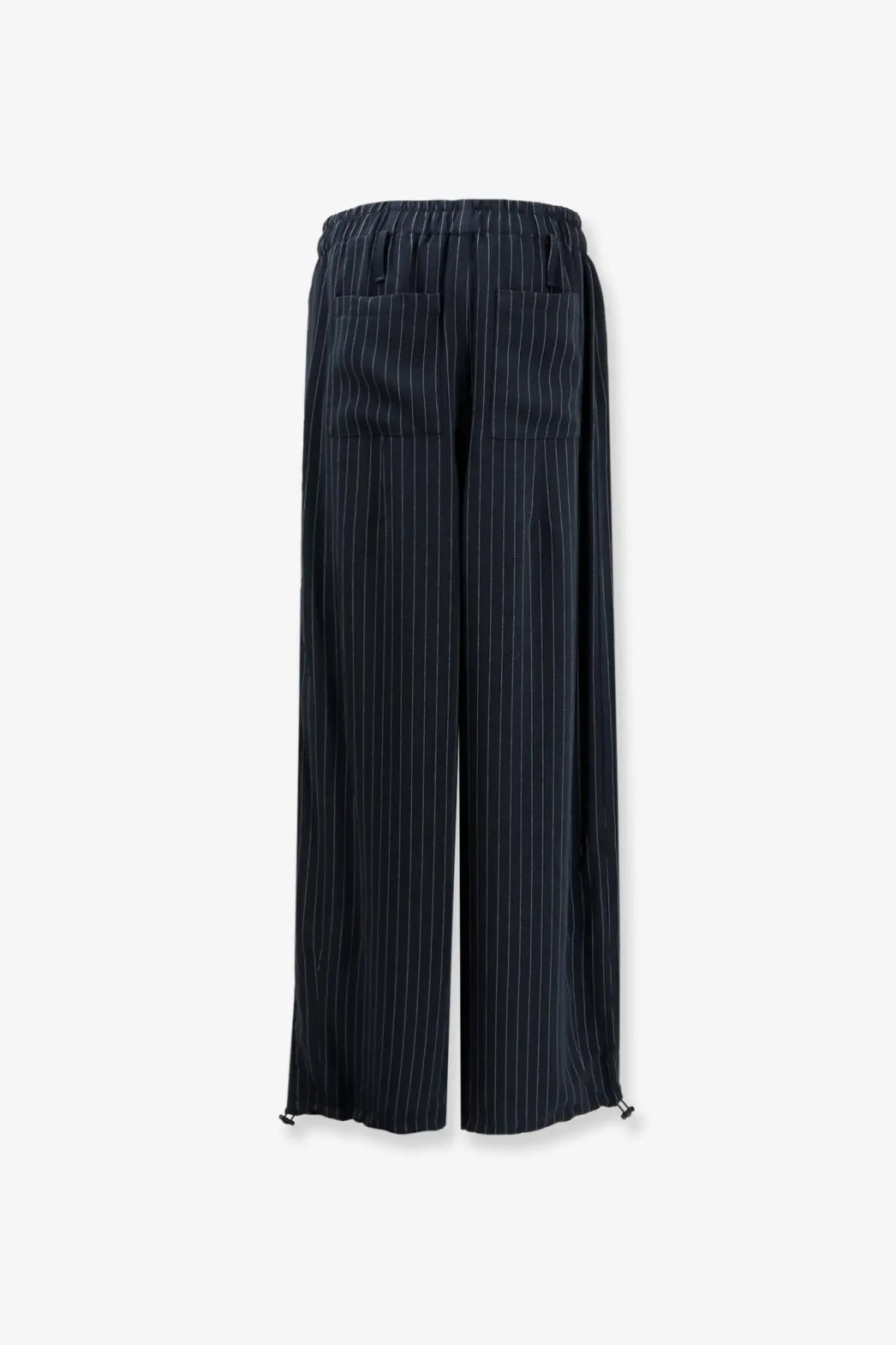 Dark navy pinstripe wide-leg trousers with elastic waistband and drawstring ties made from recycled material by the frankie shop