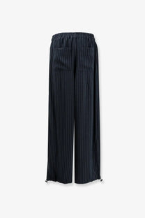 Dark navy pinstripe wide-leg trousers with elastic waistband and drawstring ties made from recycled material by the frankie shop