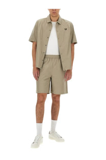 Beige short-sleeved cotton button-up shirt with subtle embroidered logo on chest for Fred Perry men’s Bermuda shorts set