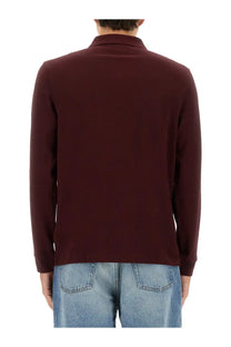 A maroon Fred Perry men’s cotton long-sleeved polo shirt with classic collar and ribbed cuffs