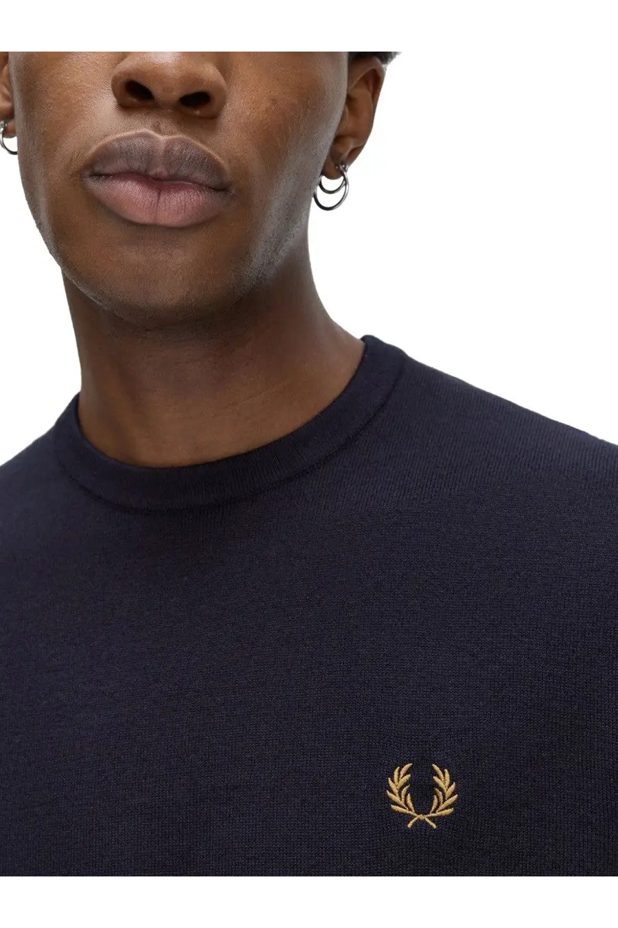 Navy blue knit crew neck sweater with gold embroidered laurel wreath logo from Fred Perry men’s jersey blue collection
