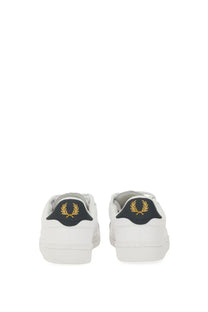 Fred Perry men’s white leather sneakers with black heel tab and gold laurel wreath logo shown from the back side