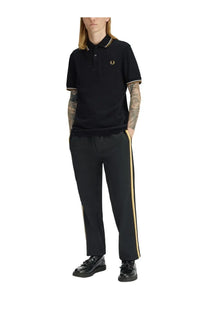 Fred perry men’s black polo shirt with gold trim on collar and cuffs and embroidered logo on chest