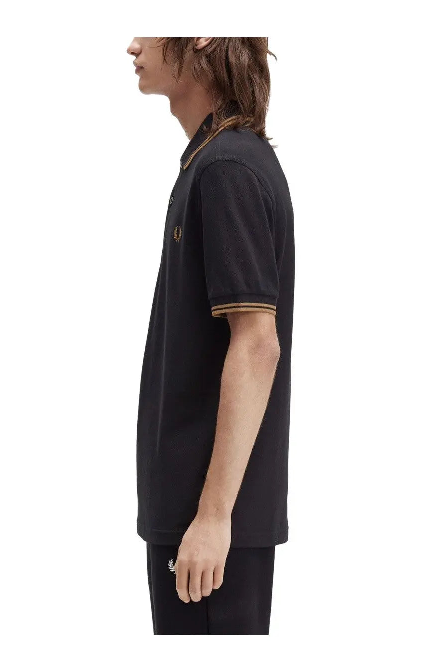 Fred Perry men’s black polo shirt with gold trim on collar and sleeve cuffs featuring classic cotton fabric