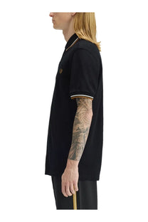 Fred Perry men’s black polo shirt with gold and white trim made from premium cotton for casual wear