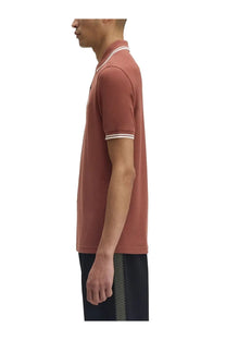 Fred Perry men’s rust-colored polo shirt with white collar and sleeve trim perfect for casual wear