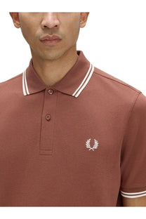 Fred perry men’s brown rust-colored pique polo shirt with white collar trim and embroidered laurel wreath logo