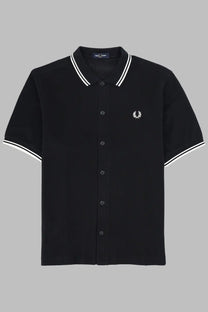 Black fred perry men’s polo shirt with white collar and sleeve trim featuring small embroidered laurel wreath logo