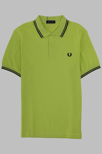 Bright lime green fred perry men’s polo con green shirt with black collar trim and embroidered laurel wreath logo