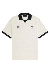 Fred Perry men’s cream-colored polo shirt with black collar, sleeve cuffs, and small embroidered chest logo