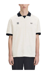 Fred Perry men’s cream-colored short-sleeved polo shirt with black collar, cuffs, and embroidered chest logo