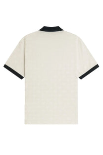 Cream-colored Fred Perry men’s polo con white with black ribbed collar and short sleeve cuffs perfect for casual wear