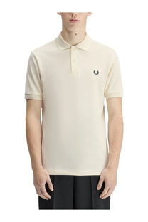 Fred Perry men’s cream-colored polo shirt with black embroidered laurel wreath logo on the chest