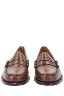 Brown leather loafers by G.H. Bass with classic penny loafer design and black rubber soles for men
