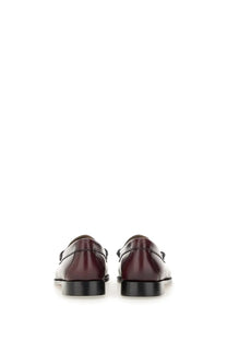 G.H. Bass women’s mocassino weejun penny red burgundy leather loafers with black rubber soles and classic moccasin design