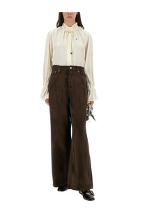 Cream-colored satin blouse with ruffled collar and long sleeves paired with ganni women’s brown baggy pants
