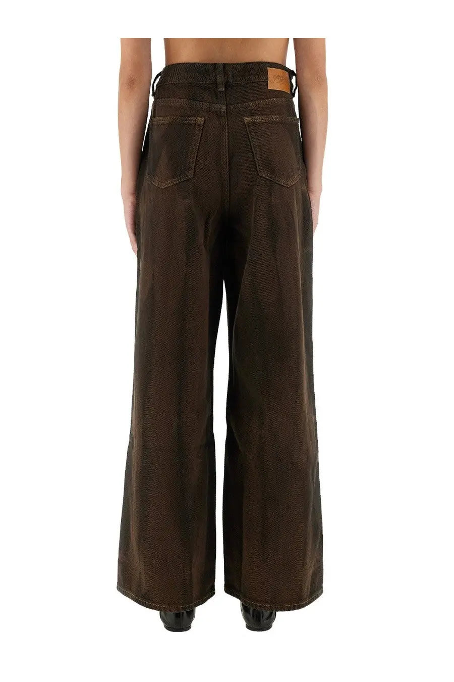 Dark brown wide-leg denim trousers with high waist and classic back pockets shown from the back by ganni women’s baggy pants brown