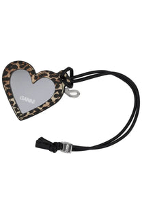 A heart-shaped mirror keychain with leopard print frame black cord featuring ganni brand name on reflective surface