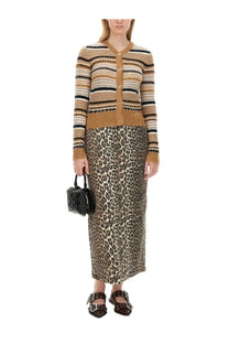 A woman wearing ganni women’s beige striped knit cardigan with gold-tone buttons over a leopard print skirt