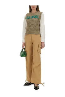 Green ganni mini bag with a structured rounded shape and top handle paired with ganni women’s beige cotton twill cargo pants