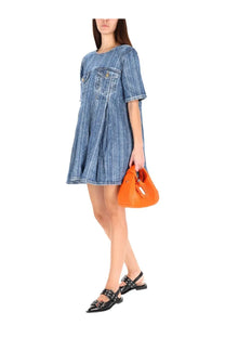 Vibrant orange leather handbag with tassel detail paired with ganni women’s blue denim dress