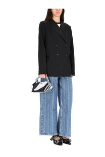 Black and white patent leather handbag with silver chain handle shown with ganni women’s double breasted wool jacket black
