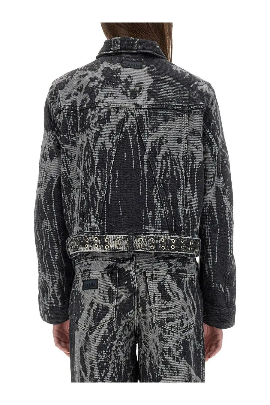 Ganni women’s heavy denim jacket in black with gray distressed denim and bold abstract splatter pattern