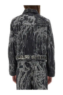 Ganni women’s heavy denim jacket in black with gray distressed denim and bold abstract splatter pattern