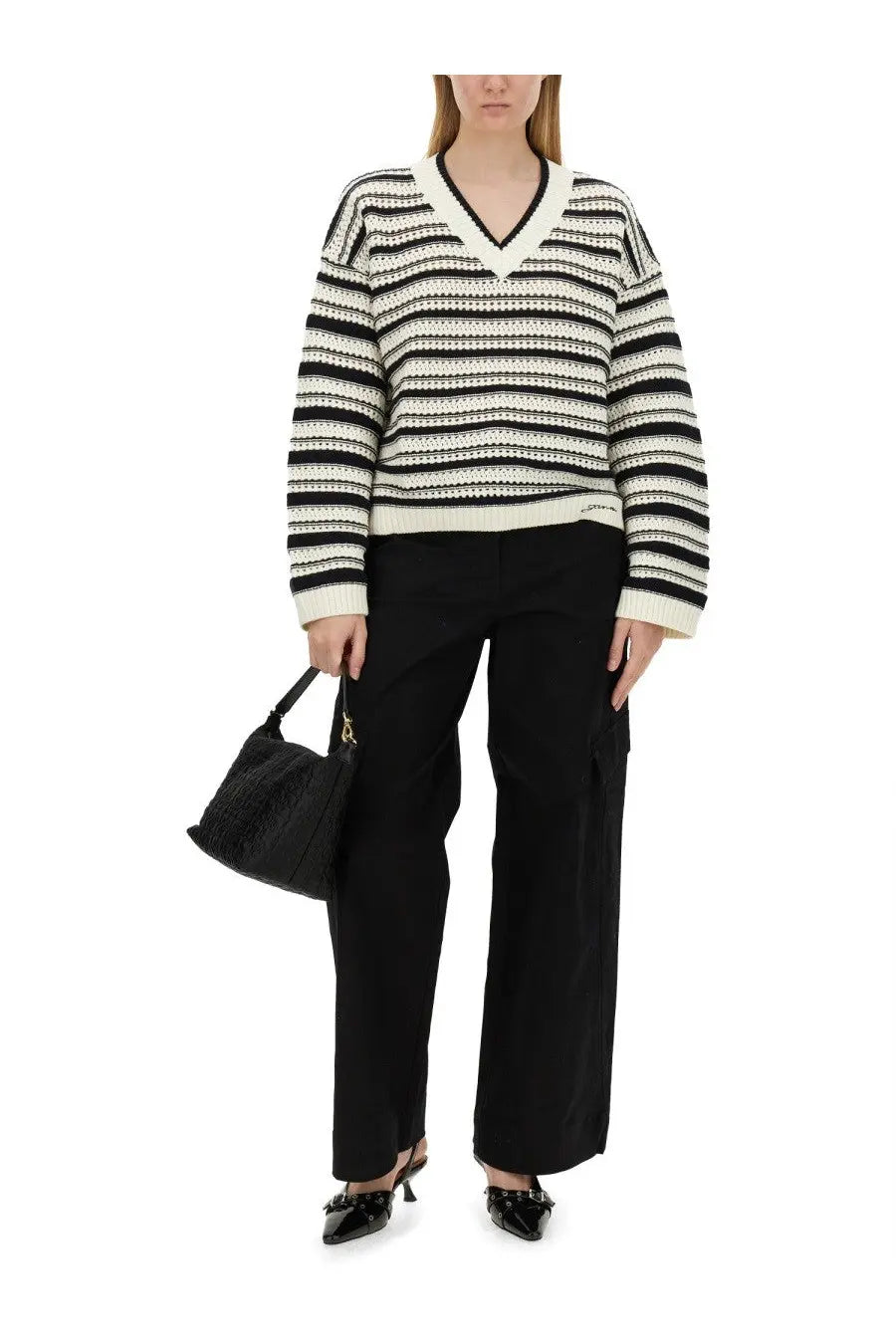 Black and white striped v-neck sweater with ribbed cuffs and hem paired with Ganni women’s herringbone pants black